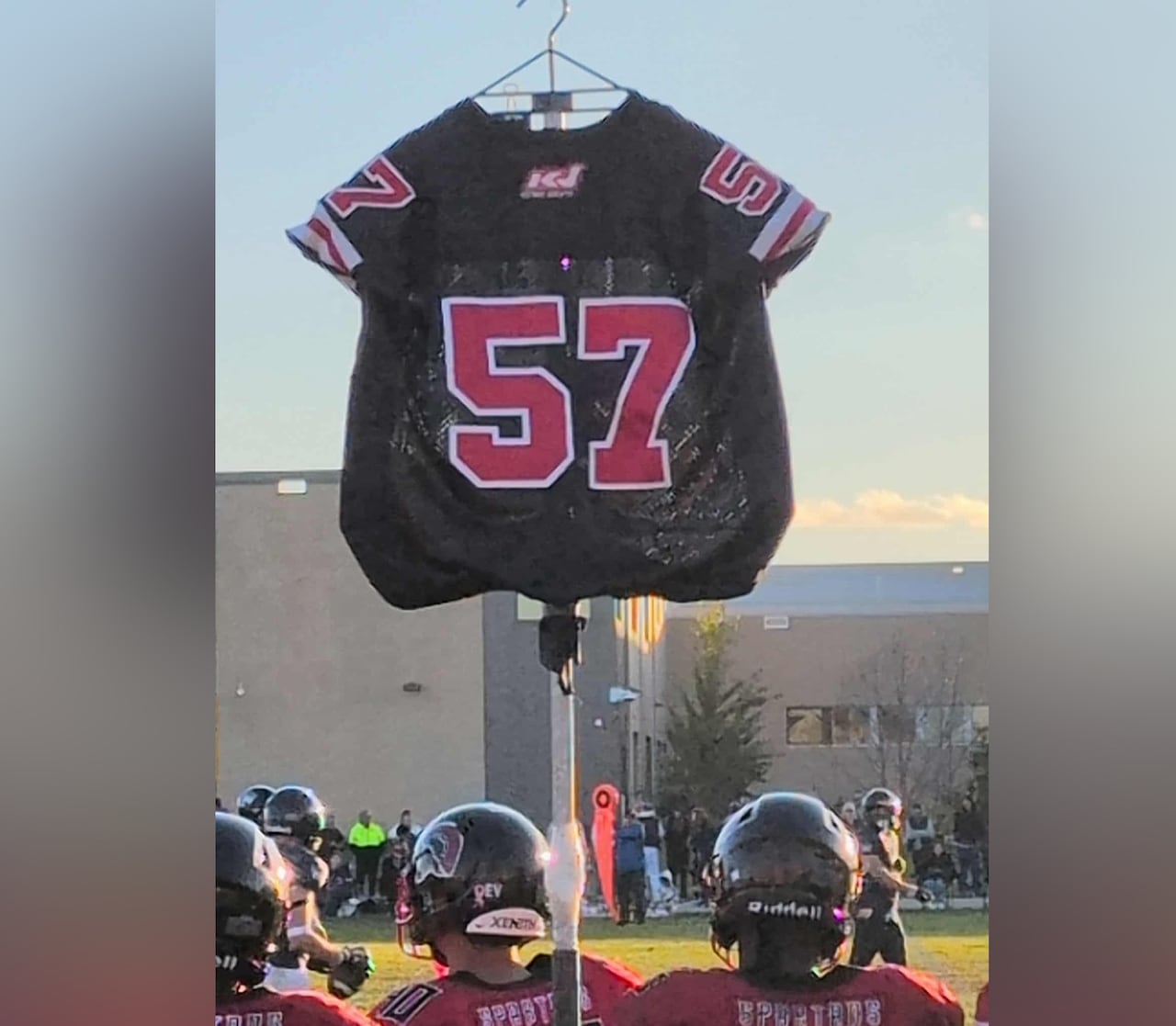 A soccer jersey is hoisted on a pole.