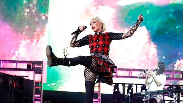 Gwen Stefani of No Doubt performs at the Coachella Stage during the 2024 Coachella Valley Music and Arts Festival at Empire Polo Club on April 20, 2024 in Indio, Calif. A woman singing into a microphone is depicted mid-kick.