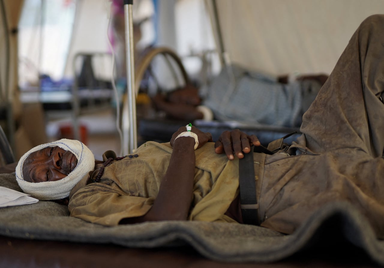 An injured and displaced Sudanese man receives treatment.