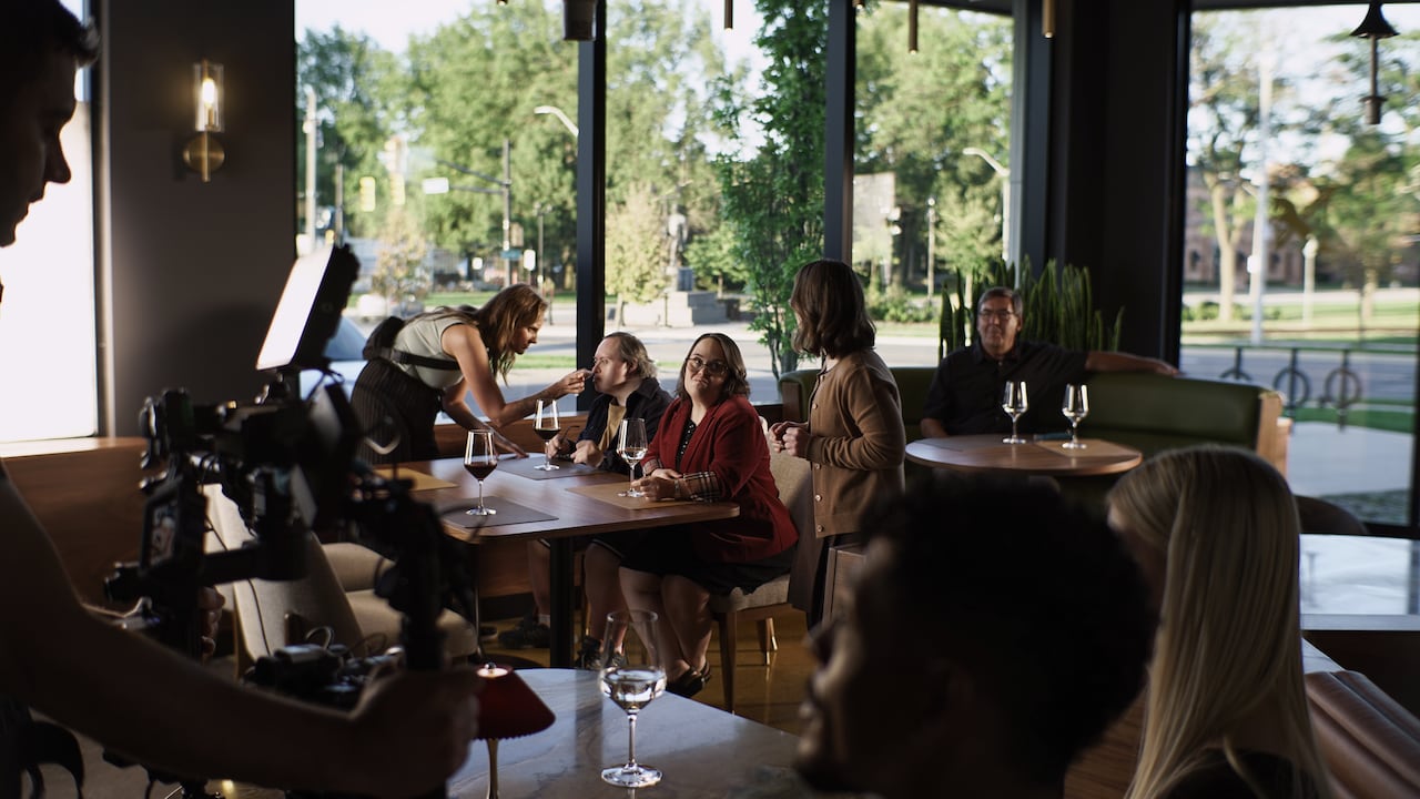 Group of people at table during filming