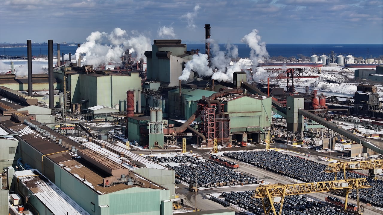 a steel mill with rolls of steel laid outside