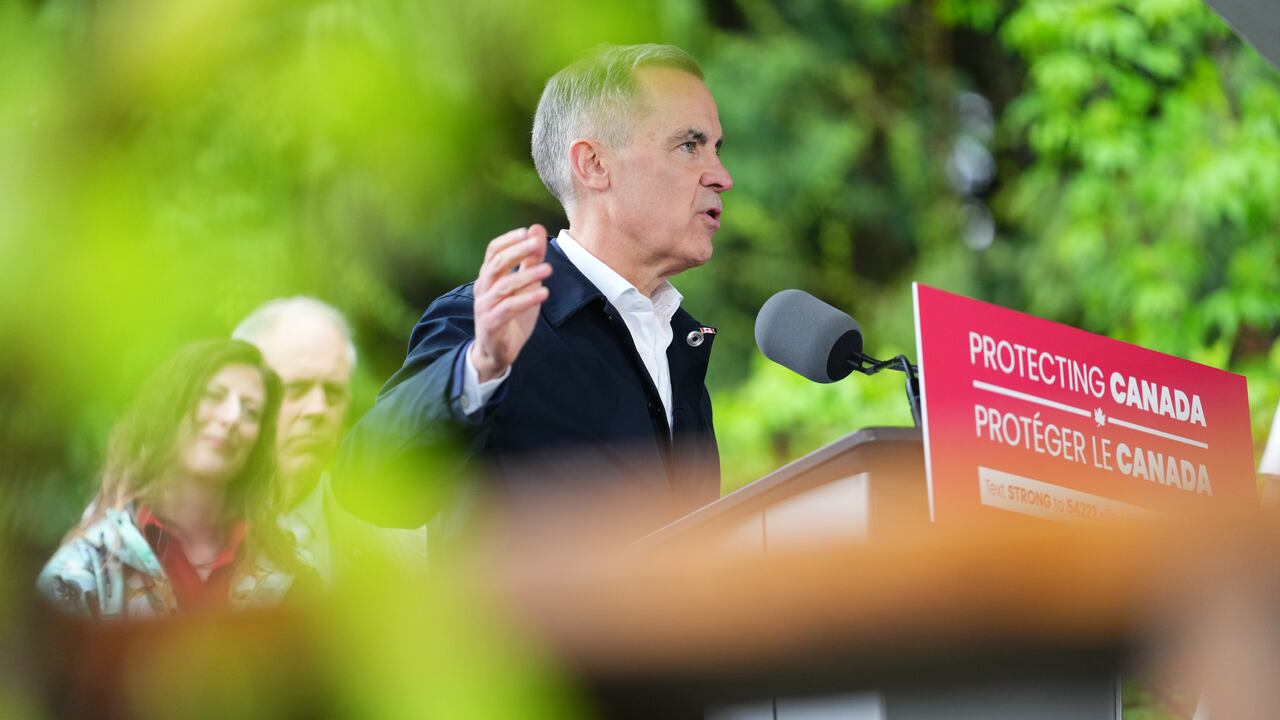A antheral   speaks from a podium outdoors.