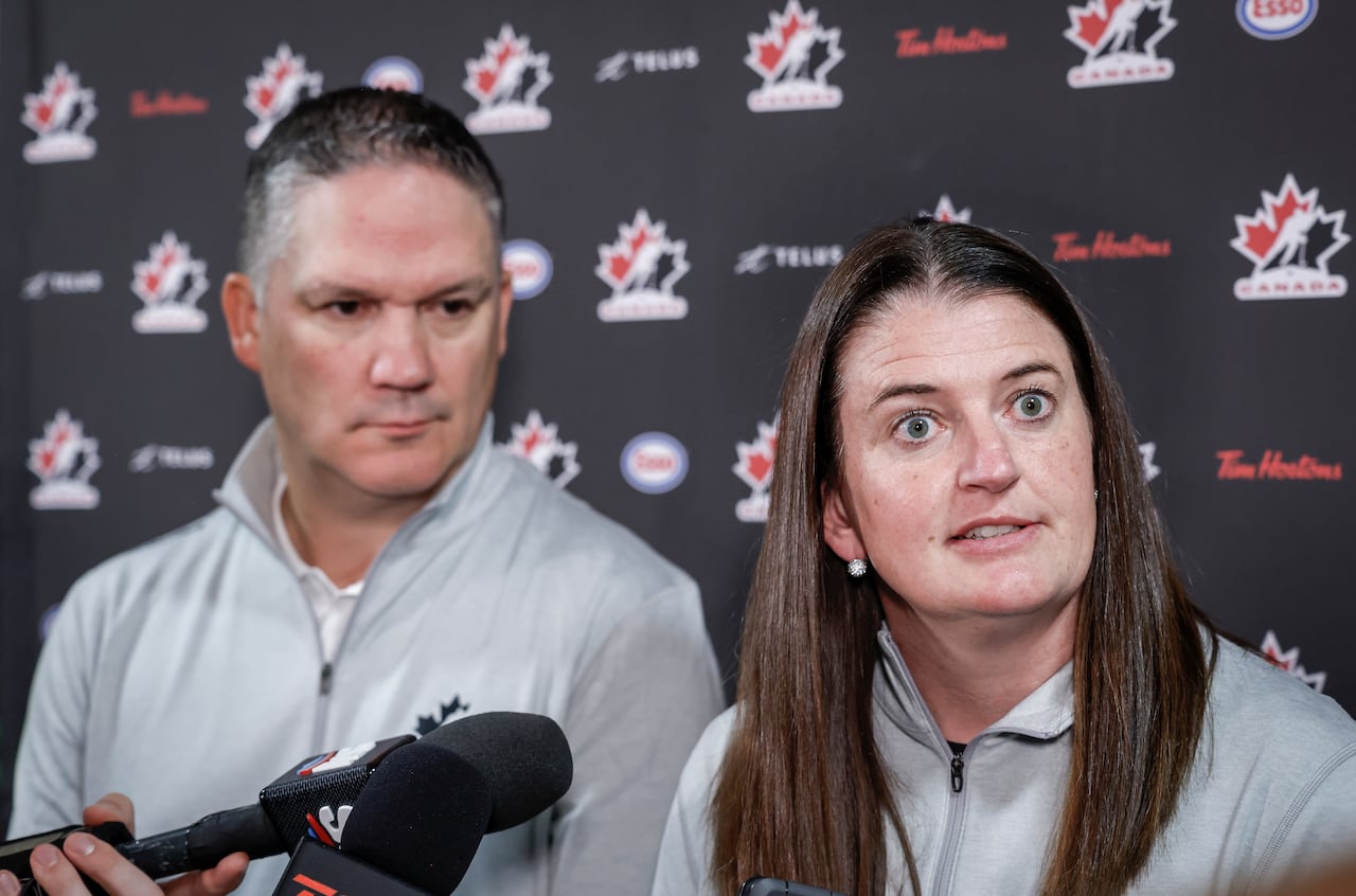 A man and a woman speak at a press conference.
