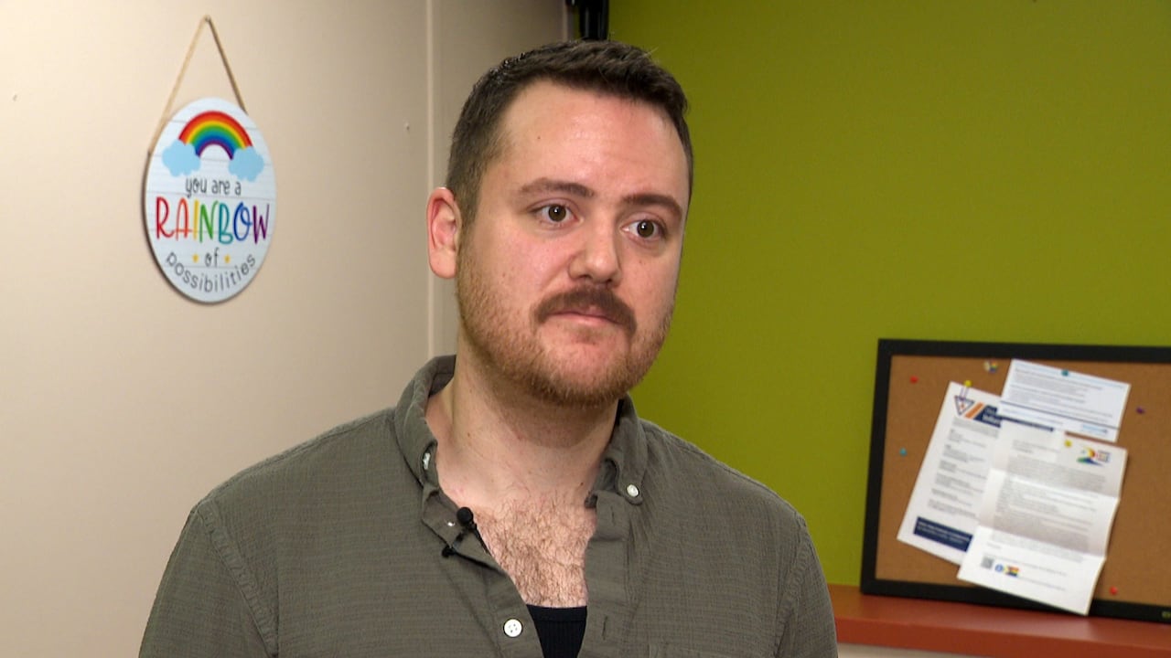 A idiosyncratic   wearing a greenish  garment  being interviewed.