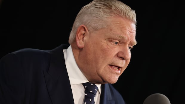 A headshot of Ontario Premiere Doug Ford speaking into a microphone