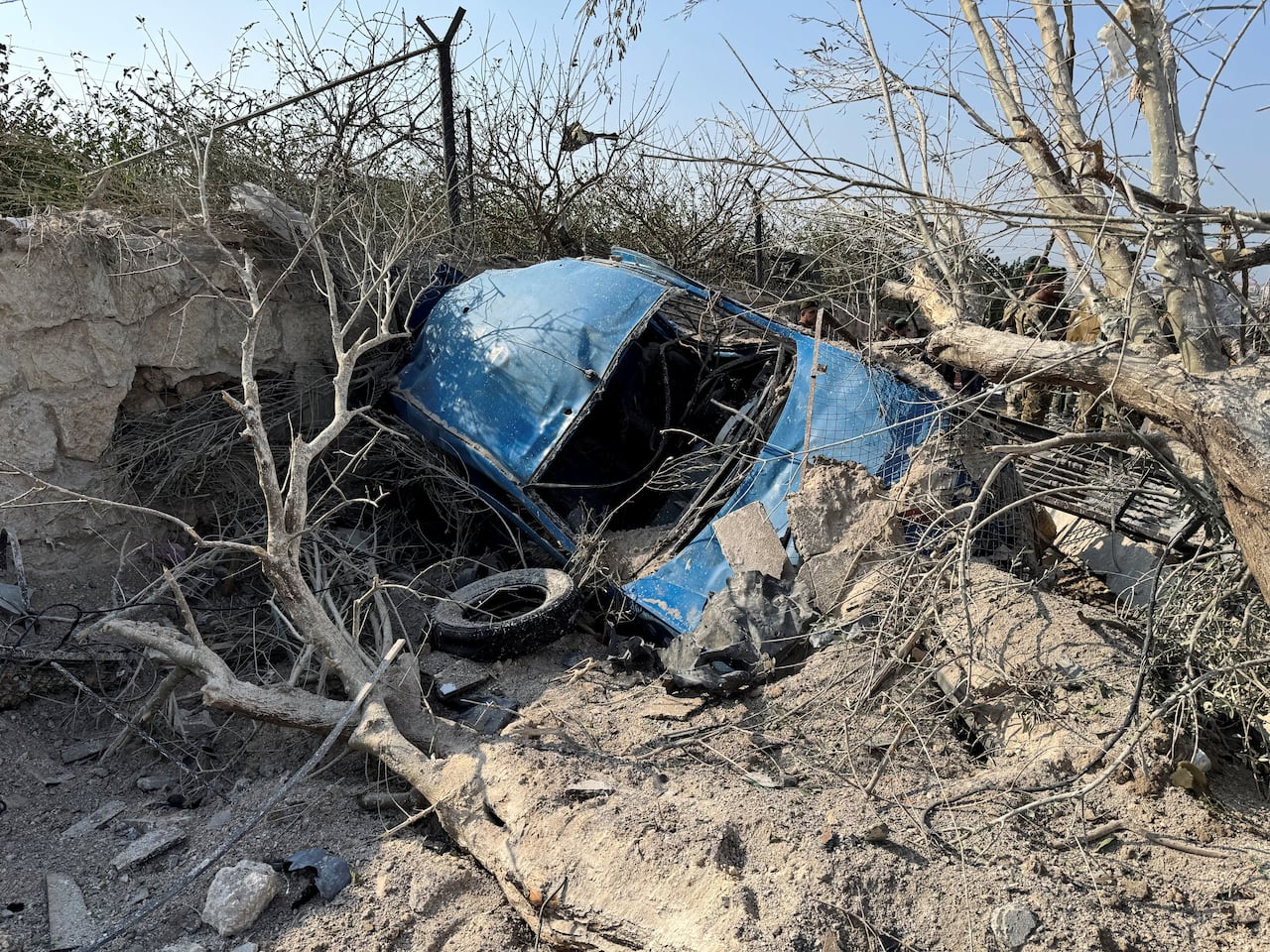 A damaged car in the aftermath of Israeli strikes.