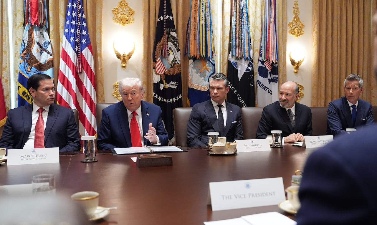 Seated at table from left to right: Marco Rubio, Donald Trump, Pete Hegseth, Howard Lutnick, and Sean Duffy.
