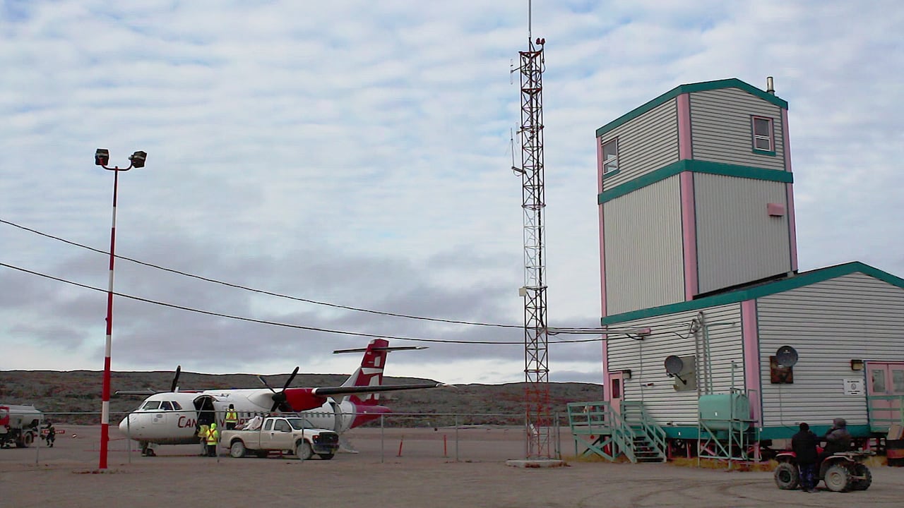 Canadian North plane next to an airport building