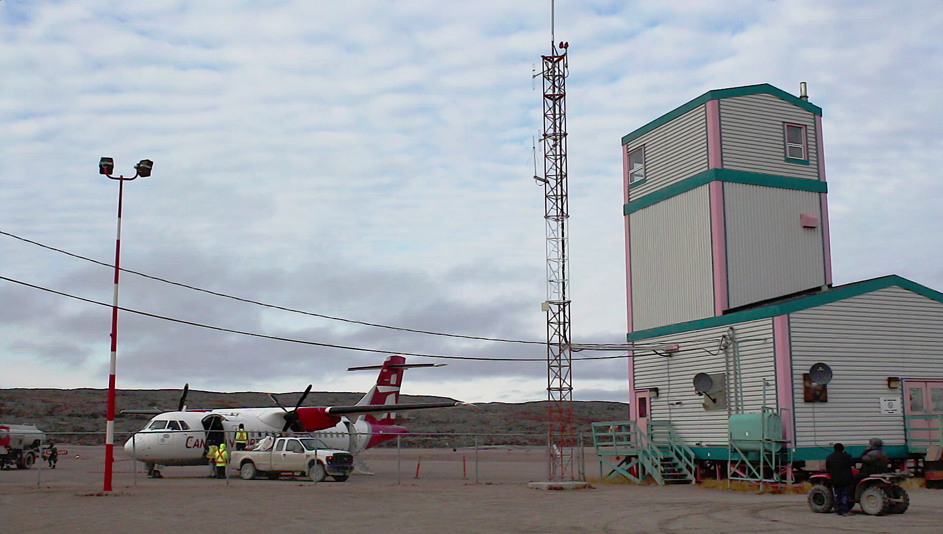 A Canadian North plane refuels outside the airport in Kugaaruk (formerly Pelly Bay), Nunavut, on Sept. 28, 2020. Canadian North plane next to an airport building