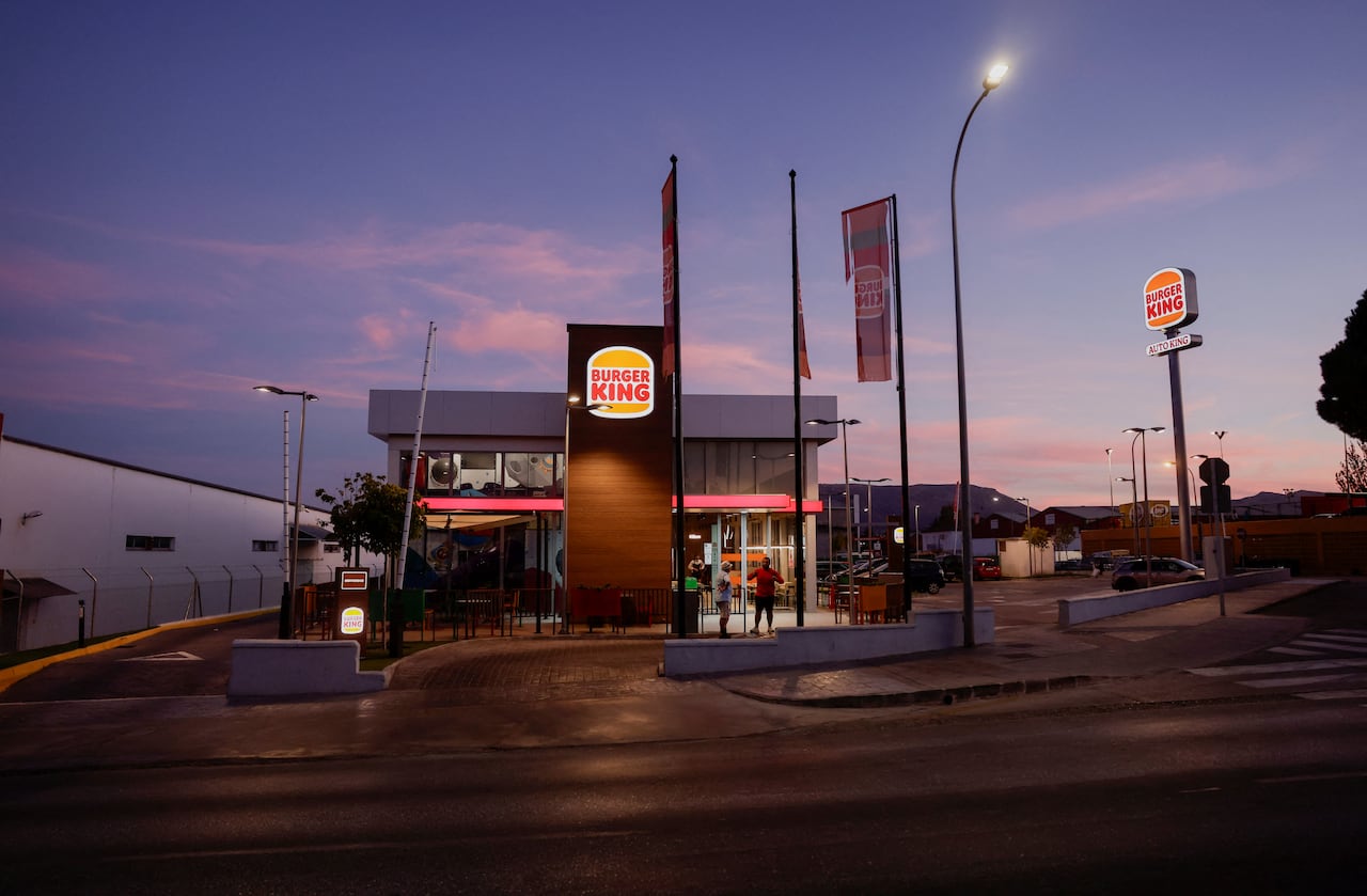 The exterior of a Burger King restaurant is shown as the sun sets.