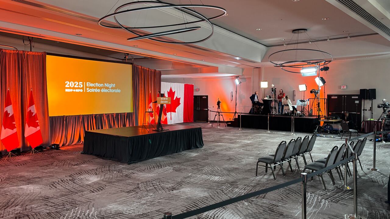 An bare  edifice  ballroom with bare  chairs.