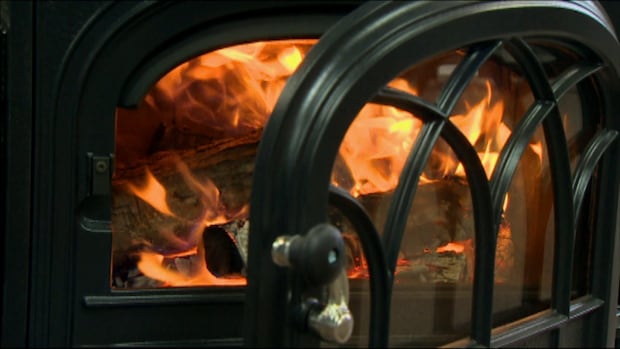 A door open on a wood-burning stove.