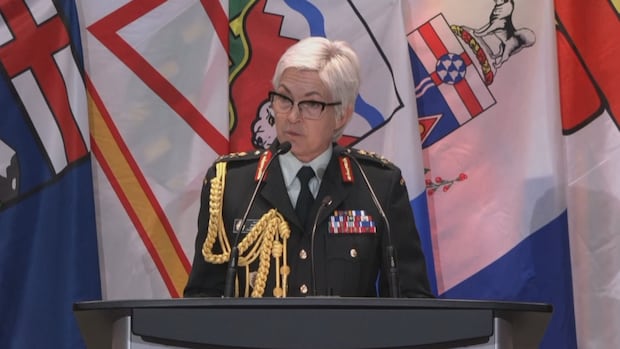 Gen. Jennie Carignan, chief of the defence staff, delivers an apology on behalf of the Canadian Armed Forces to current and former CAF members and their families who have experienced racial discrimination and racial harassment in connection to their military service in Ottawa Oct. 30, 2025. A woman with short white hair in military dress uniform speaks at a podium.