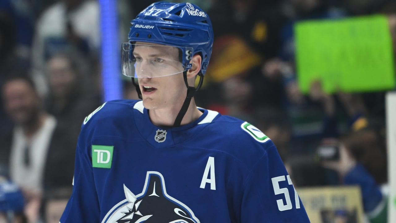 A close up of a male ice hockey player.