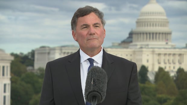 man stands at podium with white house behind him