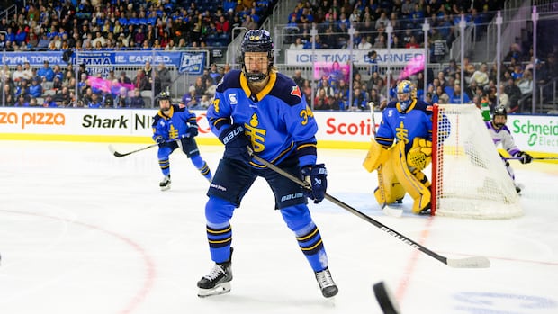 A hockey player skates on the ice.