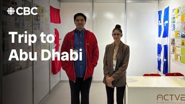 First Nations teenager in red jacket stands next to teacher in front of a science fair both. Text reads "CBC Trip to Abu Dhabi."
