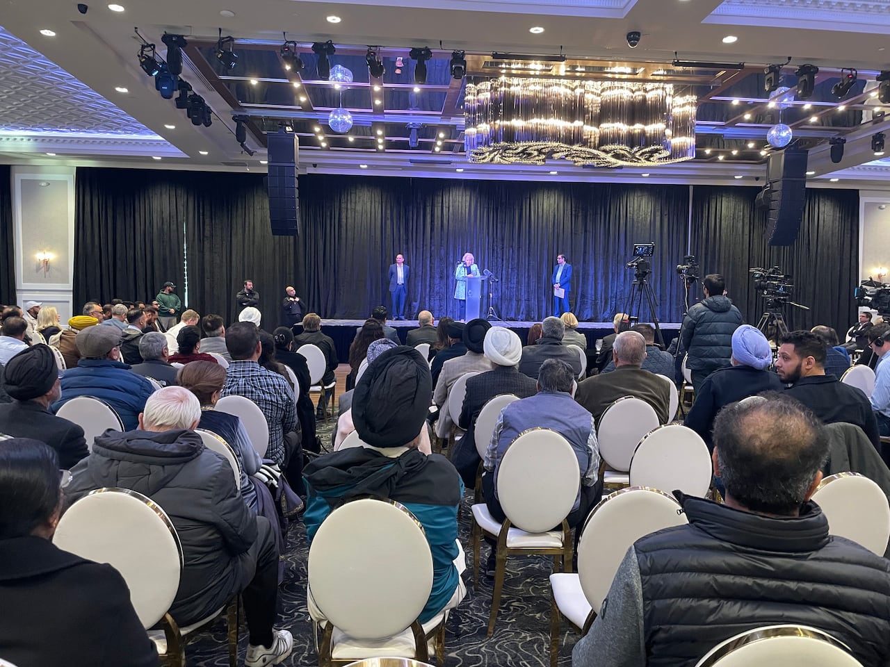 Hundreds of people attend a community event raising concerns about extortion in January, 2024.