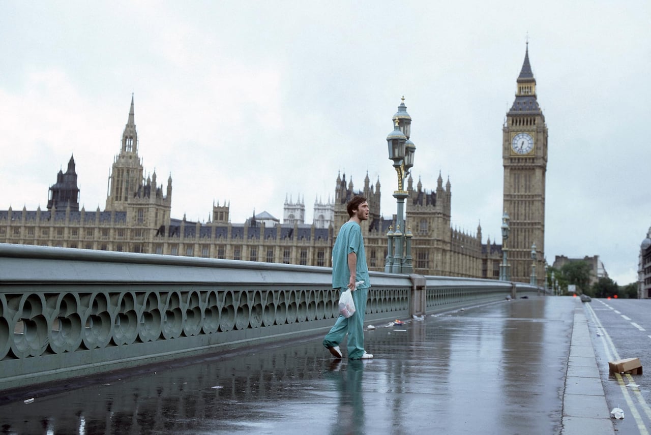 A man walking across an empty Westminster Bridge.