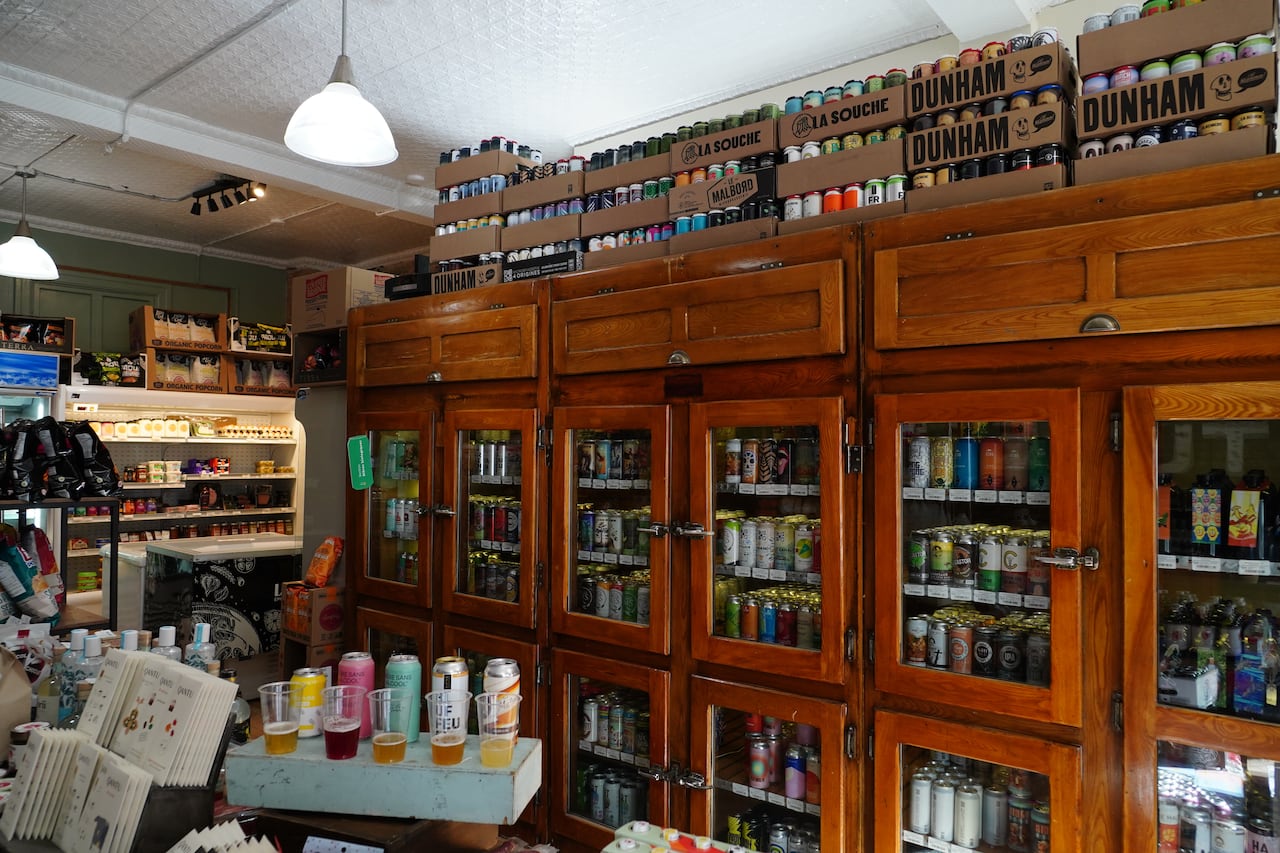 Display of non-alcoholic beer and spirits in glass-door refrigerators at a specialty store in Montreal.