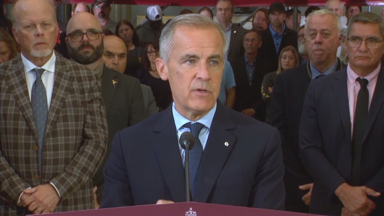 Prime Minister Carney at podium with microphone in front of crowd