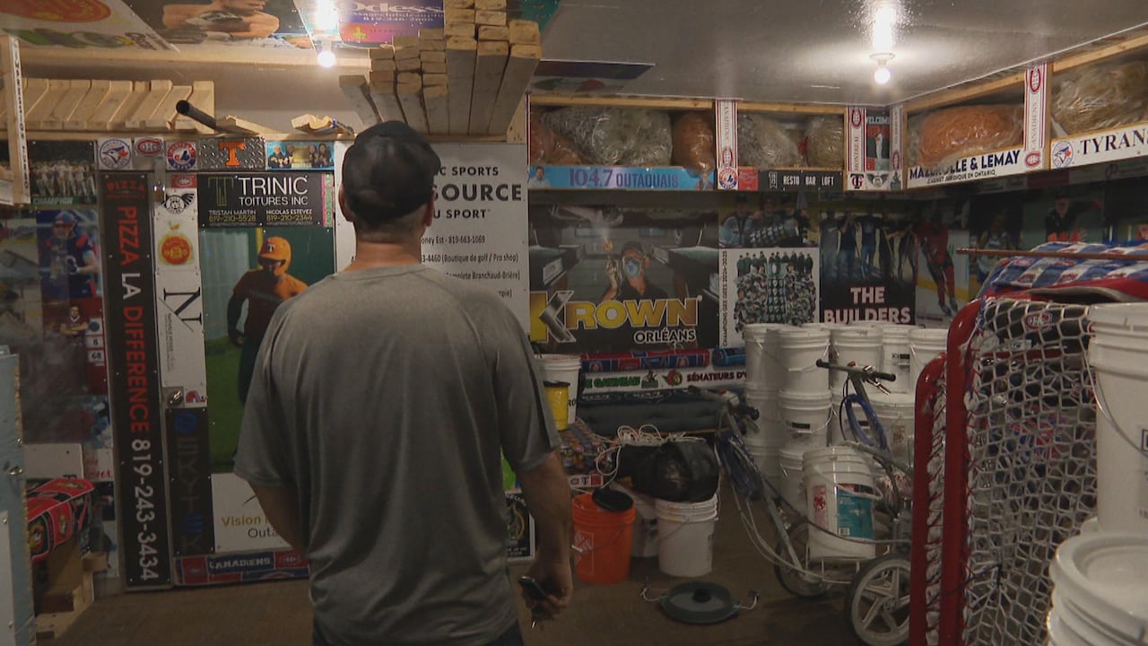 A man looks at posters on the wall of a skate shack