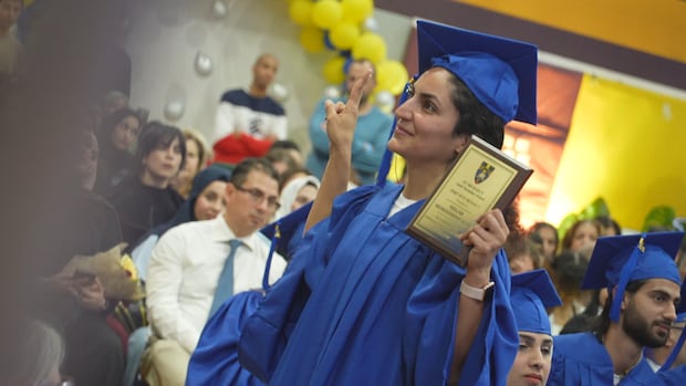 A student celebrates with an award