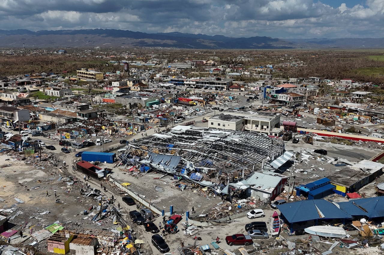An aerial view shows buildings and homes destroyed.