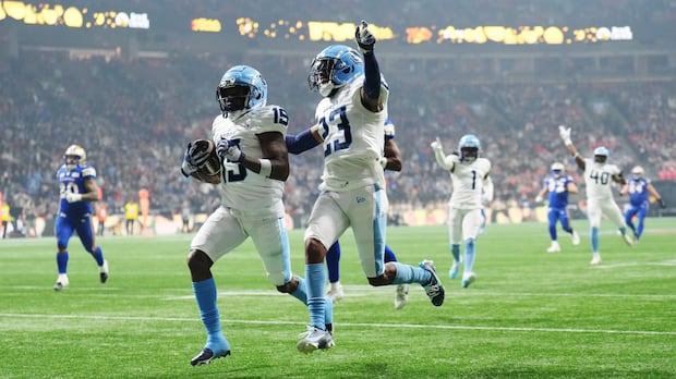 Toronto Argonauts' Robert Priester scores a touchdown after an interception against the Winnipeg Blue Bombers during the 111th Grey Cup in Vancouver in 2024. A new survey suggests most CFL fans are OK with proposed rule changes for the league. A football player runs with the ball with a teammate next to him and opposing team members in pursuit.