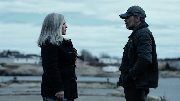 Bonavista, N.L., mayor John Norman recounts the moment his bright, remote community was transformed into an eerie, run-down Lumon factory town for the hit Apple TV series Severance. two people talk in a remote location