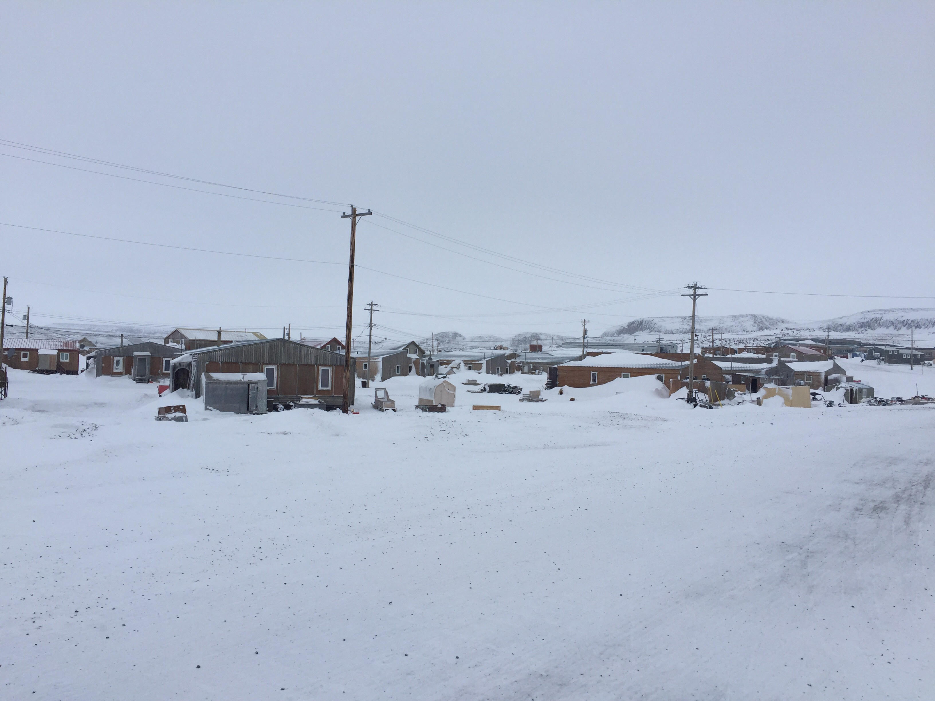 The Hamlet of Ulukhaktok. Strong winds on Saturday brought down power lines, causing a community-wide outage. houses surrounded by power lines
