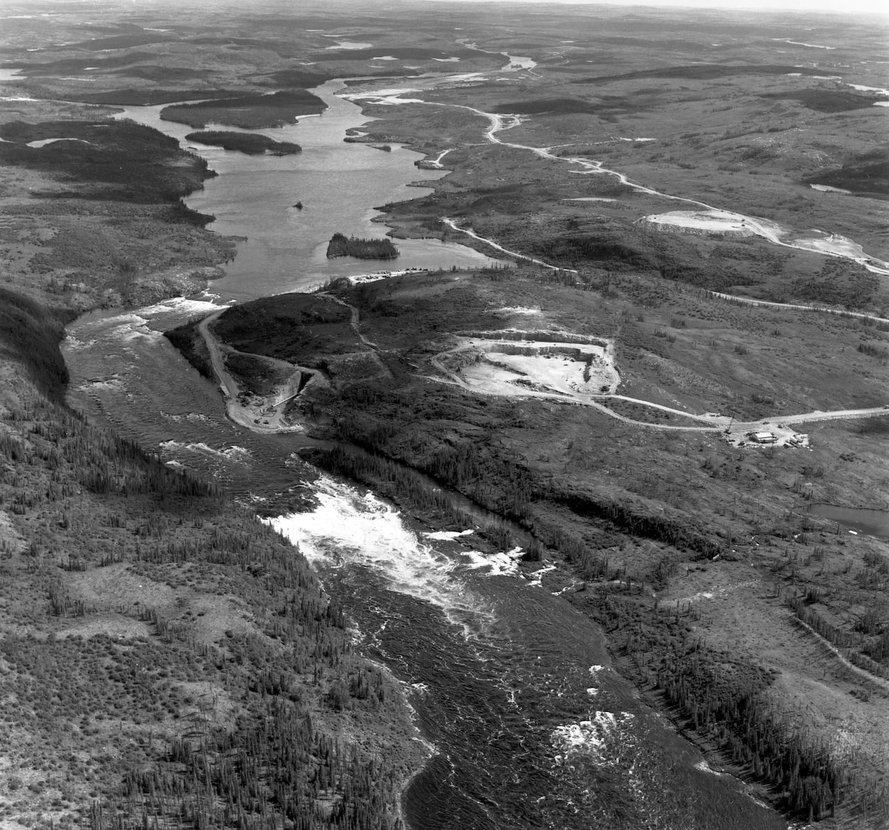 An aerial shot of a river in black and white 