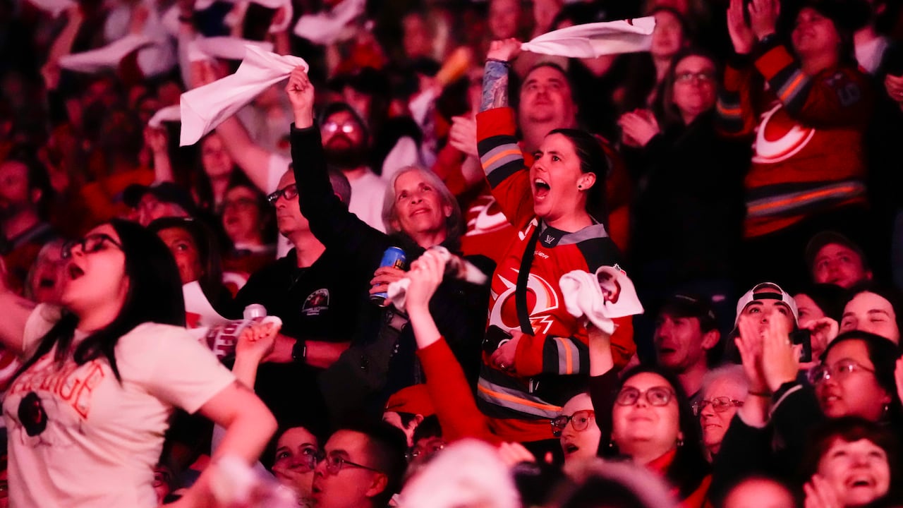 Ottawa Charge fans cheer at a hockey game.