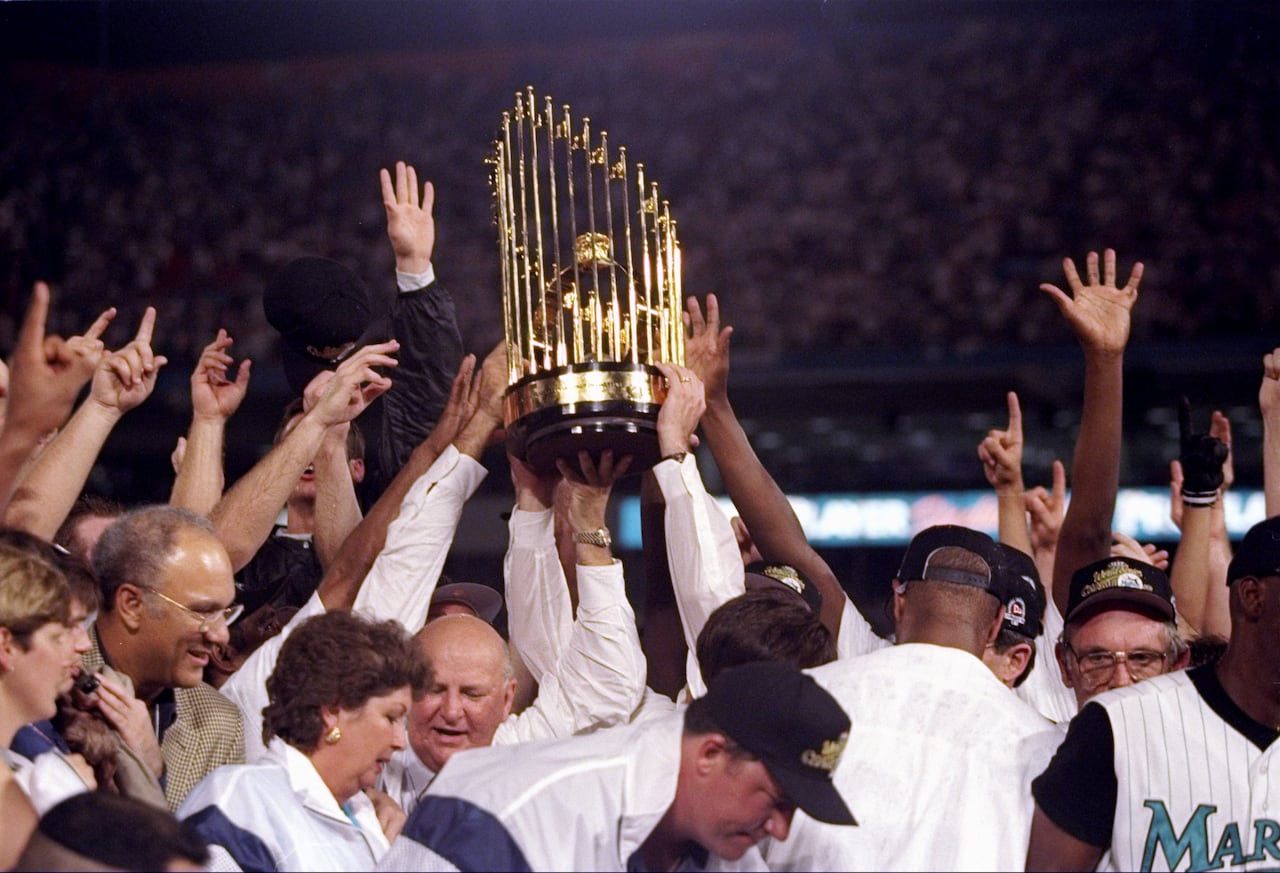 Players lift the trophy into the air