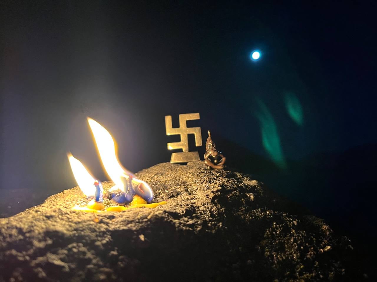 A swastika, candles and another figure used in a ceremony.