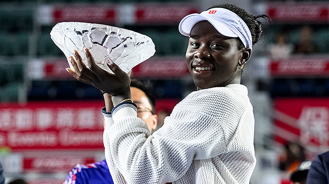 Canadian tennis player Victoria Mboko holds winner's trophy after a three-set victory over Cristina Bucsa of Spain at the Hong Kong Open on November 2, 2025. 