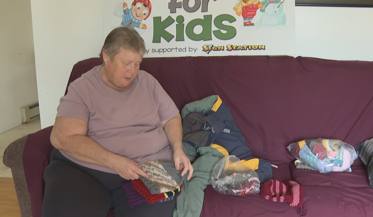 A pistillate sitting connected a sofa examining wintertime covering and accessories