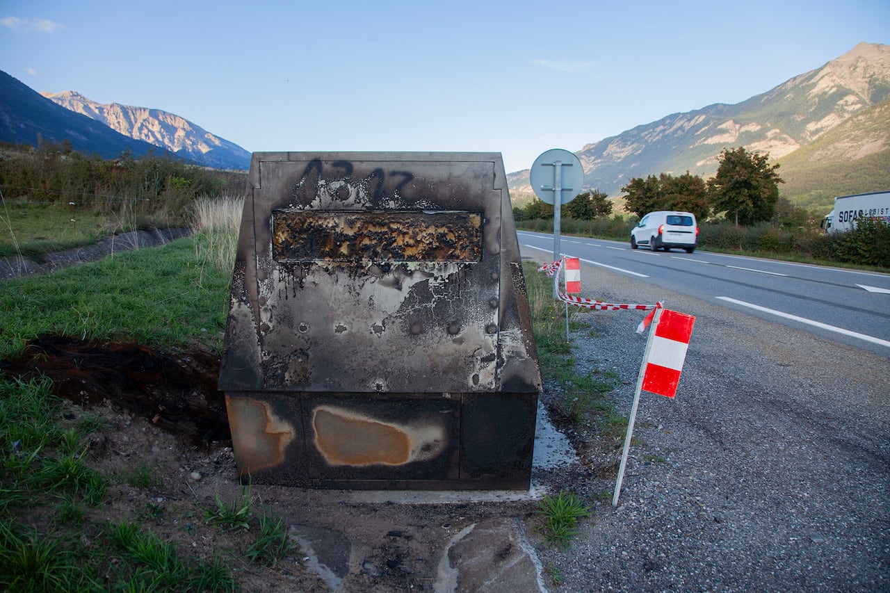 Destroyed speed camera on the side of the road.