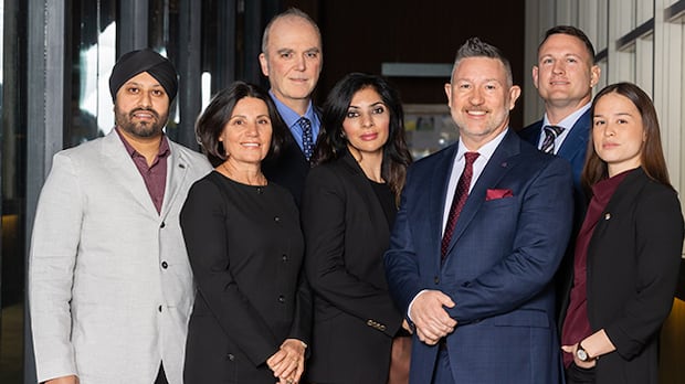 Vancouver Park Board Commissioners from left to right: Jas Virdi, Marie-Claire Howard, Tom Digby, Angela Haer, Scott Jenson, Brenan Bastyovansky and Laura Christensen. A group of men and women in formal wear pose for a group photograph.
