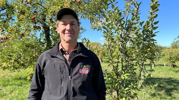 Tim Petch, Petch Orchards A man smiles standing in an apple orchard