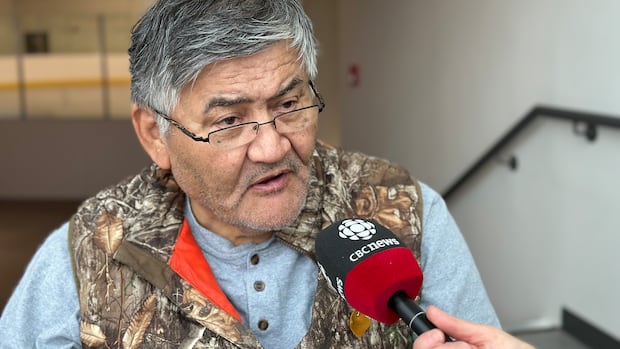 Chief Russell Blackjack, pictured on Oct. 17, 2025. He is decrying a lack of proper consultation on the Yukon's new minerals legislation.  man in glasses and a vest speaks to somebody holding a microphone