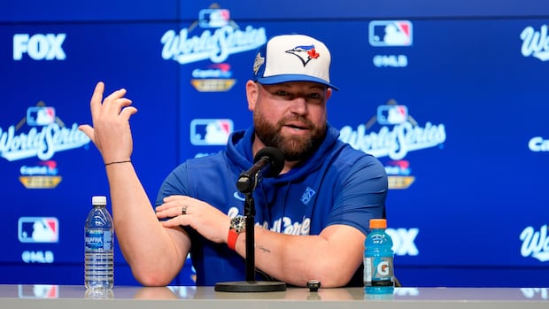 A man sits at a desk. 
