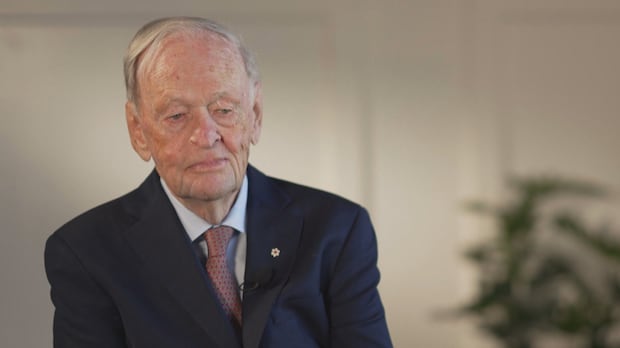 Former Liberal prime minister Jean Chrétien says Canada needs to fight for its values in the face of threats from U.S. President Donald Trump, but there will be challenges since the country needs to sell its goods. A man with short white hair wearing a blue suit