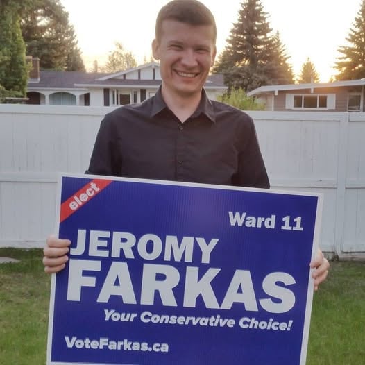 Person smiles with a sign