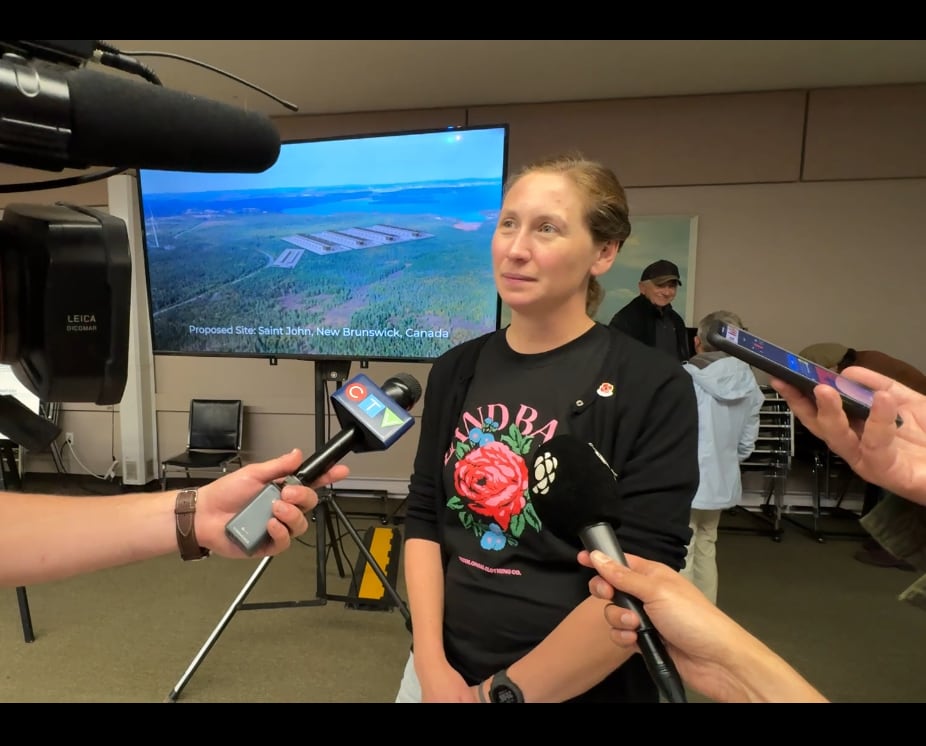 Woman, sepeaking to reporters, each  holding microphones successful  beforehand   of her.