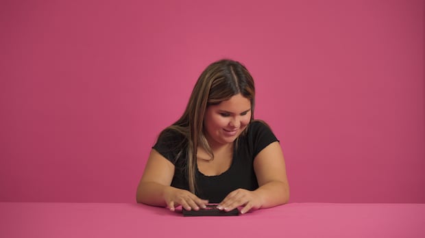 Scarlette French, who is from Oneida Nation of the Thames, is the inspiration behind a new accessible makeup palette. Scarlette's Palette contains three lip and cheek creams, two highlighters and one powder blush, as indicated by tactile symbols inside the case. A girl inside a bright pink room touches the top of a makeup palette case.