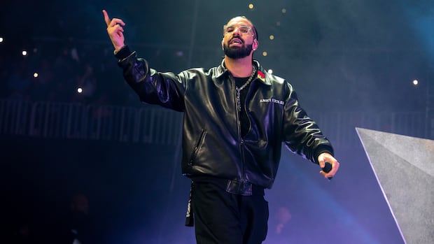 Drake performs during Lil Baby's Birthday Party at State Farm Arena on Saturday, Dec. 9, 2022, in Atlanta. Drake wins best melodic rap performance Grammy for his contribution to Future's Wait for U. A man wearing a black leather jacket and black pants gestures while on stage, with a microphone in his other hand.