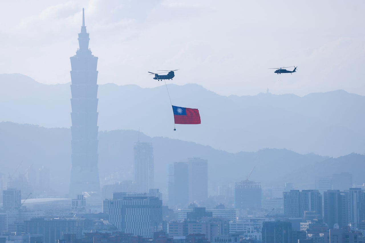 Two helicopters appear flying over the sky sky.