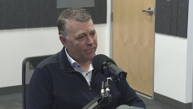 P.E.I. Premier Dennis King A short haired man sits in front of a microphone