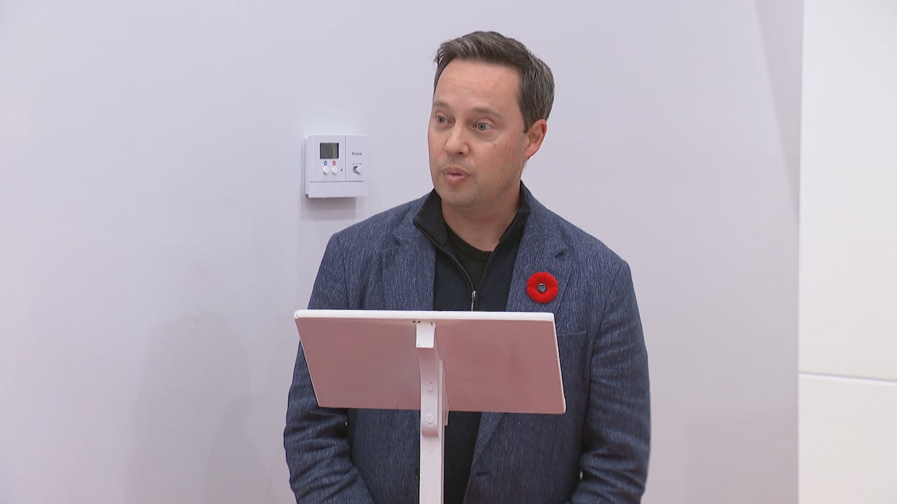 A antheral successful a bluish suit astatine a podium.